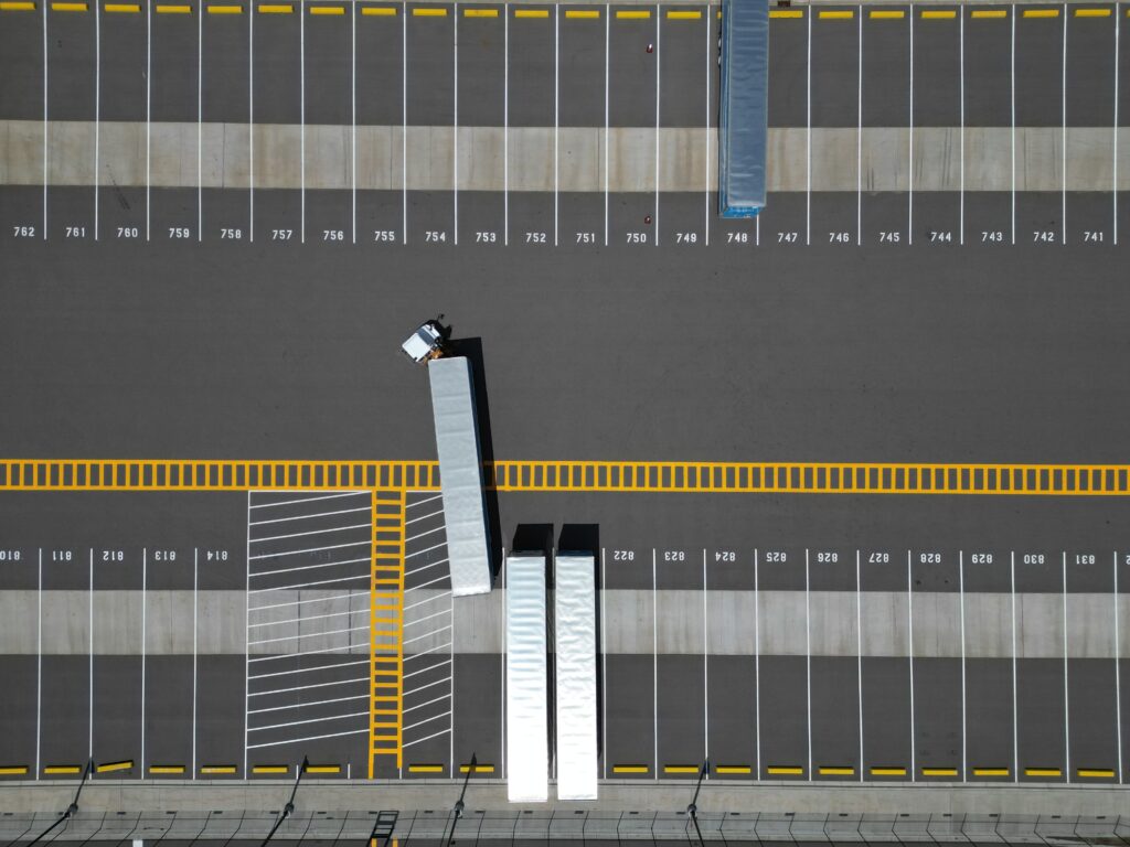 Numbered trailer stalls and yellow safety striping at a commercial truck yard